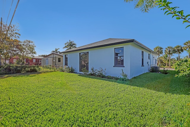 311 Ocean Pkwy, Boynton Beach, FL 33435 - view of side of home featuring stucco siding and a lawn