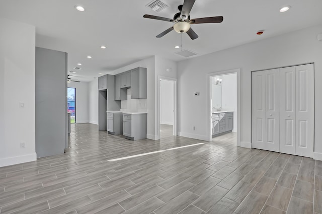 311 Ocean Pkwy, Boynton Beach, FL 33435 - unfurnished living room with visible vents, baseboards, wood tiled floor, recessed lighting, and a ceiling fan
