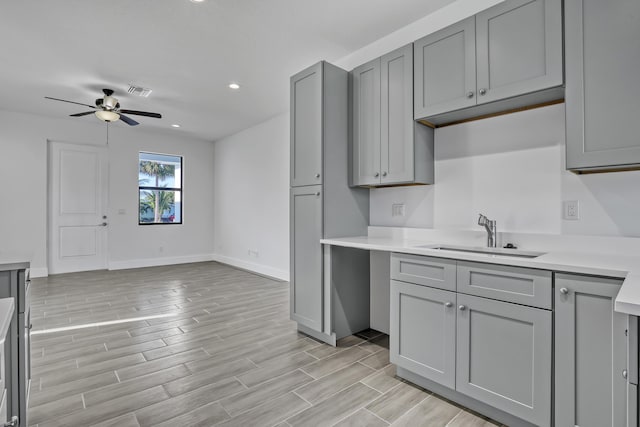 311 Ocean Pkwy, Boynton Beach, FL 33435 - kitchen featuring a sink, gray cabinetry, ceiling fan, and wood tiled floor