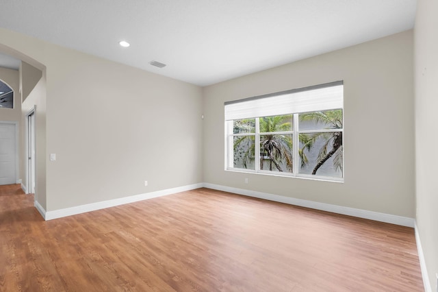 13594 Morocca Lake Ln, Delray Beach, FL 33446 - spare room with arched walkways, light wood-type flooring, baseboards, and recessed lighting