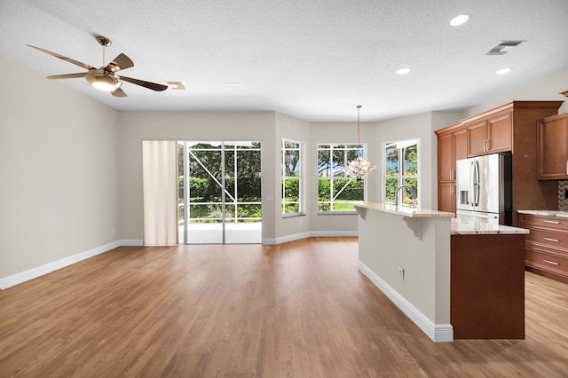 13594 Morocca Lake Ln, Delray Beach, FL 33446 - kitchen with stainless steel fridge, baseboards, plenty of natural light, recessed lighting, and a textured ceiling