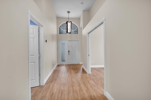 13594 Morocca Lake Ln, Delray Beach, FL 33446 - entryway with light wood-style flooring, baseboards, and a chandelier