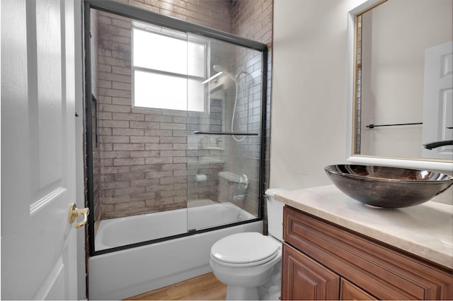13594 Morocca Lake Ln, Delray Beach, FL 33446 - full bathroom featuring vanity, combined bath / shower with glass door, toilet, and wood finished floors