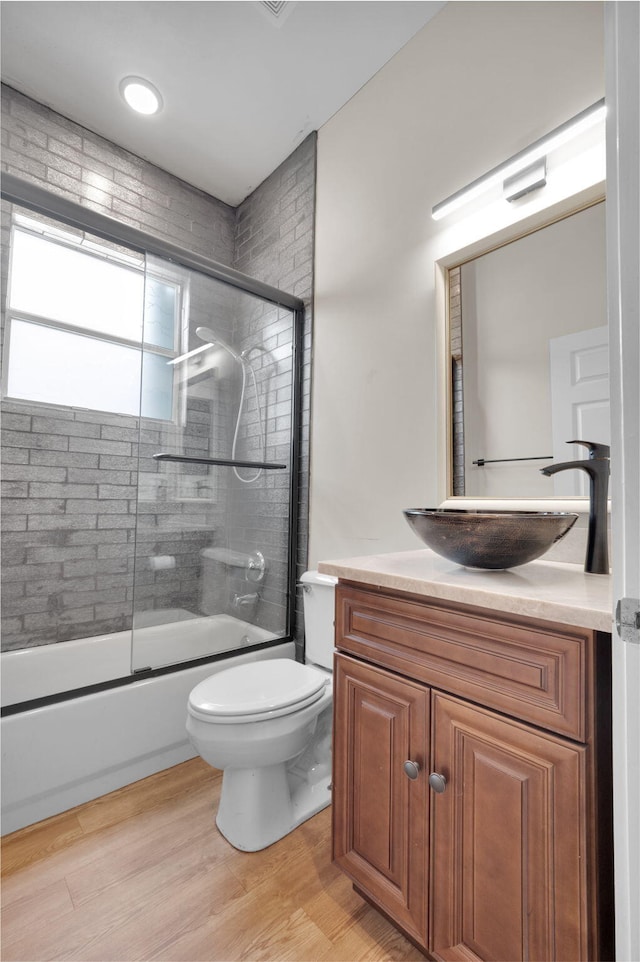 13594 Morocca Lake Ln, Delray Beach, FL 33446 - full bath with vanity, shower / bath combination with glass door, toilet, and wood finished floors