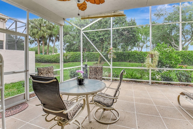 sunroom with a ceiling fan