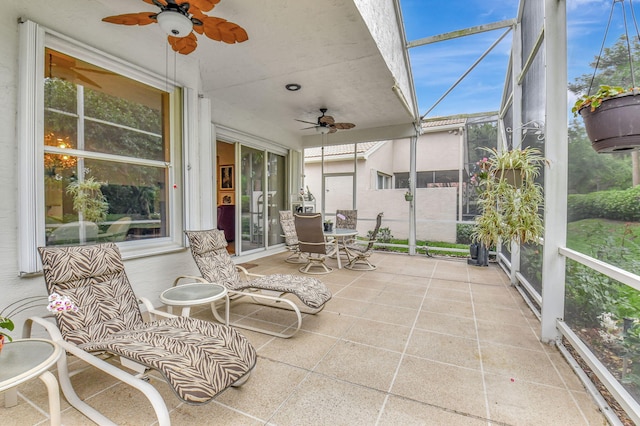 sunroom featuring a wealth of natural light and ceiling fan