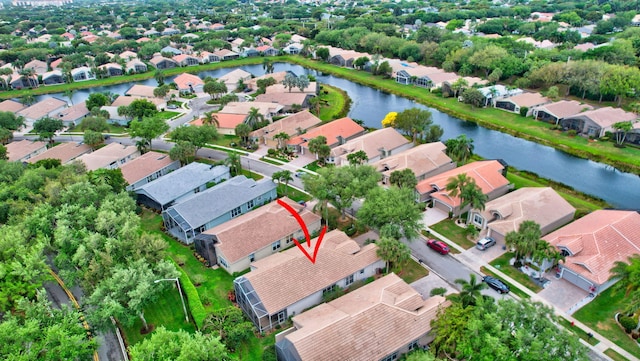 birds eye view of property with a residential view and a water view