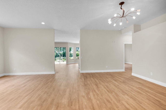 13594 Morocca Lake Ln, Delray Beach, FL 33446 - unfurnished living room featuring a chandelier, baseboards, light wood-style floors, and recessed lighting
