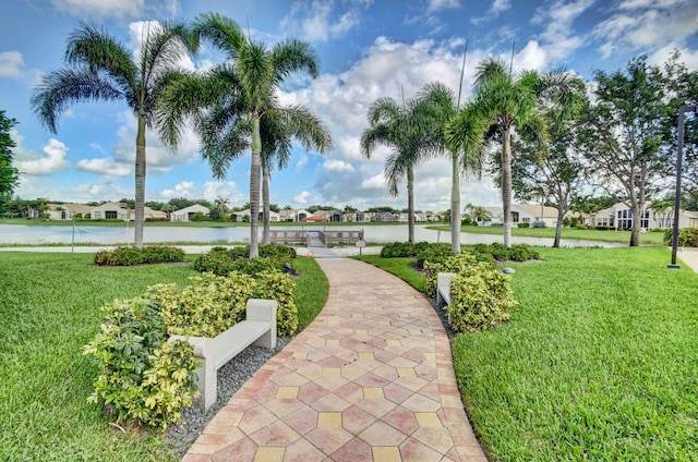 view of community featuring a yard, a water view, and a residential view