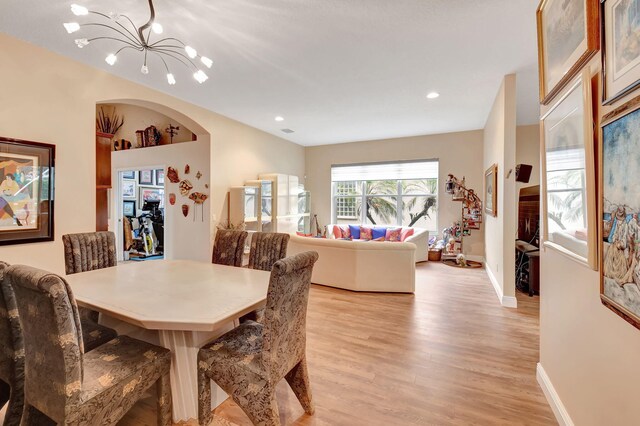 dining area featuring a chandelier, recessed lighting, light wood-style flooring, and baseboards