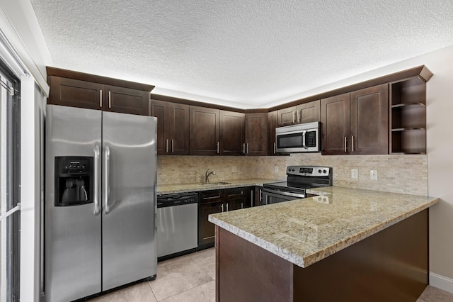 9940 NW 6th Pl, Plantation, FL 33324 - kitchen with open shelves, dark brown cabinets, decorative backsplash, a peninsula, and appliances with stainless steel finishes