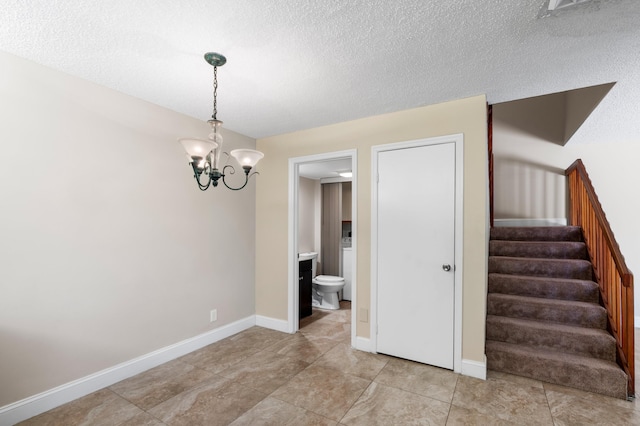 9940 NW 6th Pl, Plantation, FL 33324 - interior space with a textured ceiling, baseboards, and a notable chandelier