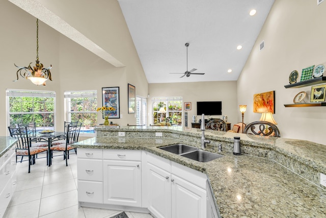 6106 Vista Linda Ln, Boca Raton, FL 33433 - kitchen with a sink, ceiling fan, high vaulted ceiling, and light stone countertops