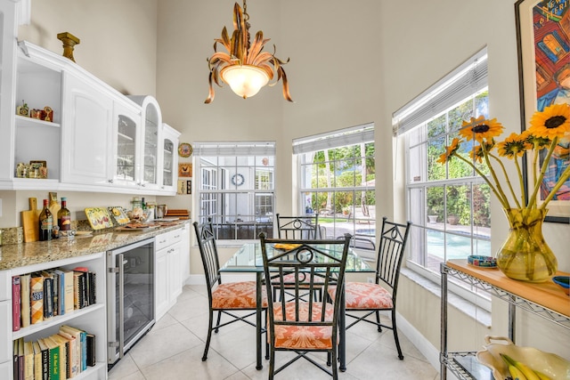 6106 Vista Linda Ln, Boca Raton, FL 33433 - kitchen with a towering ceiling, open shelves, white cabinets, a healthy amount of sunlight, and beverage cooler