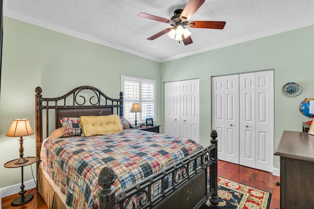 6106 Vista Linda Ln, Boca Raton, FL 33433 - bedroom featuring baseboards, a textured ceiling, crown molding, multiple closets, and wood finished floors