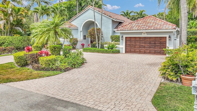 6106 Vista Linda Ln, Boca Raton, FL 33433 - mediterranean / spanish home featuring a garage, stucco siding, decorative driveway, and a tile roof