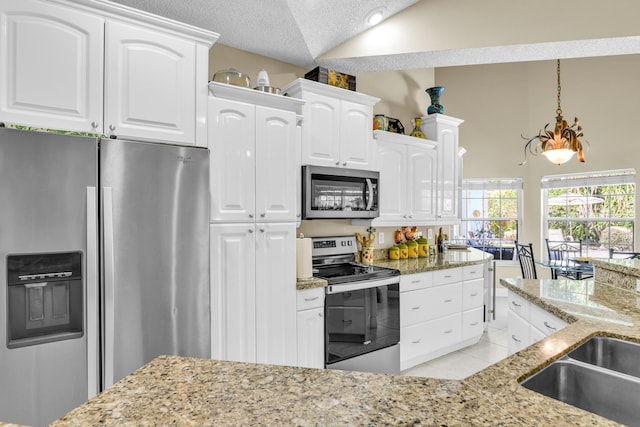 6106 Vista Linda Ln, Boca Raton, FL 33433 - kitchen with stainless steel appliances, light tile patterned floors, light stone counters, and lofted ceiling