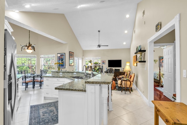 6106 Vista Linda Ln, Boca Raton, FL 33433 - kitchen featuring white cabinetry, stainless steel refrigerator with ice dispenser, ceiling fan, high vaulted ceiling, and a sink