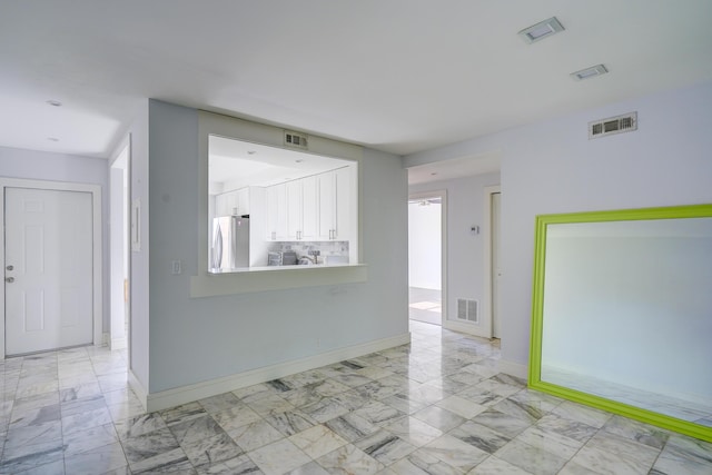 140 Lake Meryl Dr Unit 133, West Palm Beach, FL 33411 - empty room featuring light marble finish flooring and baseboards