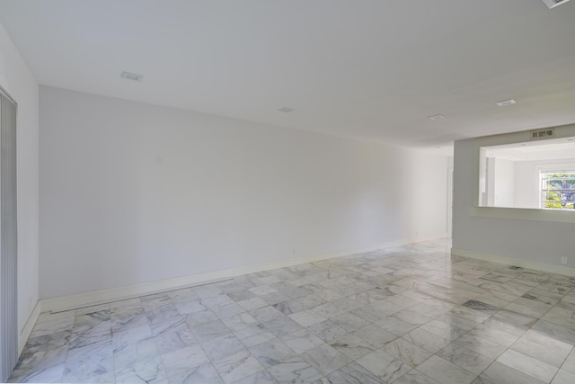 140 Lake Meryl Dr Unit 133, West Palm Beach, FL 33411 - spare room featuring light marble finish flooring and baseboards