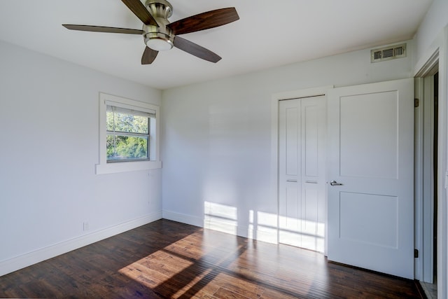 140 Lake Meryl Dr Unit 133, West Palm Beach, FL 33411 - unfurnished bedroom with baseboards, dark wood-style floors, a closet, and a ceiling fan