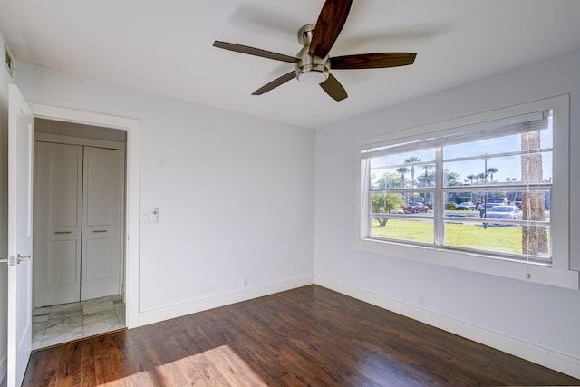 140 Lake Meryl Dr Unit 133, West Palm Beach, FL 33411 - unfurnished bedroom featuring baseboards, dark wood-style flooring, and ceiling fan