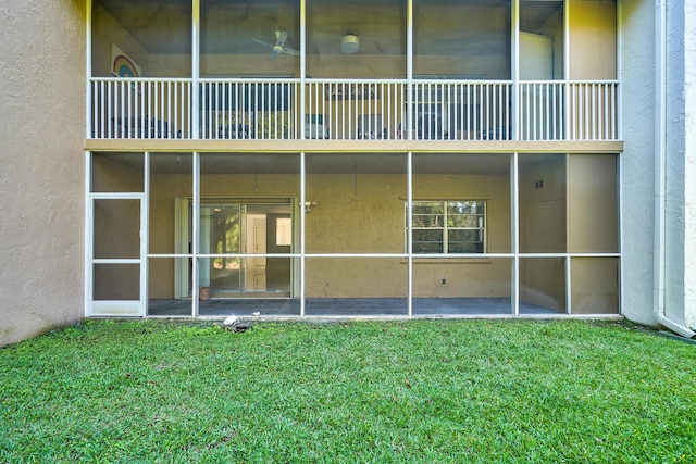 140 Lake Meryl Dr Unit 133, West Palm Beach, FL 33411 - back of property with stucco siding and a yard
