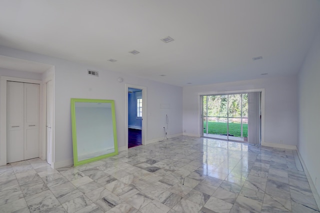140 Lake Meryl Dr Unit 133, West Palm Beach, FL 33411 - unfurnished room with light marble finish flooring and baseboards