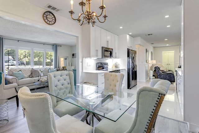 dining area featuring a notable chandelier, visible vents, and recessed lighting