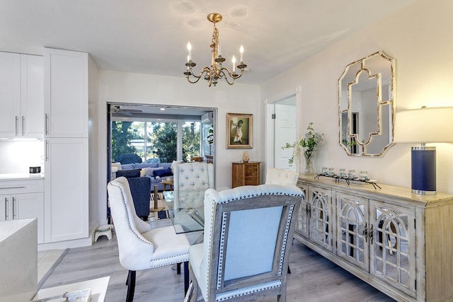 dining area with an inviting chandelier and light wood-style flooring