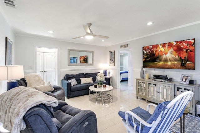 living room featuring light tile patterned floors, visible vents, and crown molding