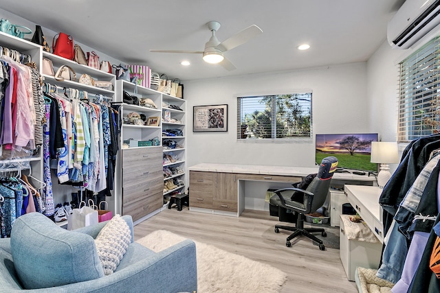 office area featuring a ceiling fan, a wall unit AC, recessed lighting, and light wood-style floors