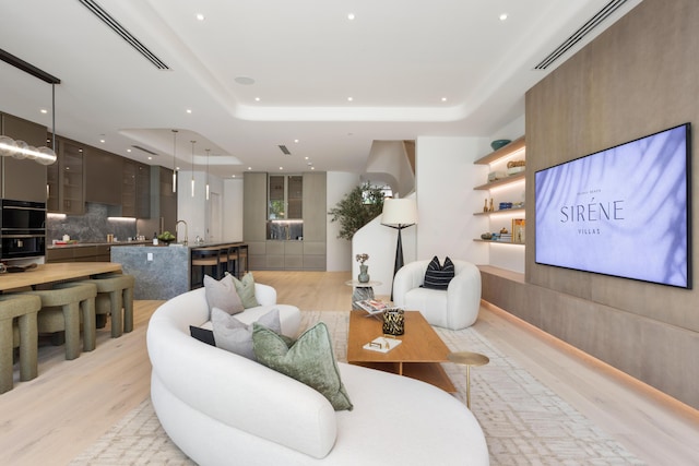 1246 George Bush, Delray Beach, FL 33483 - living room with recessed lighting, a tray ceiling, visible vents, and light wood-style flooring