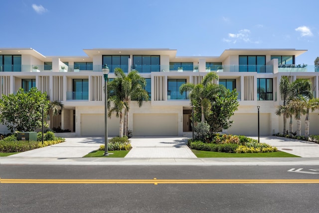 1246 George Bush, Delray Beach, FL 33483 - view of front of house featuring an attached garage, driveway, and stucco siding