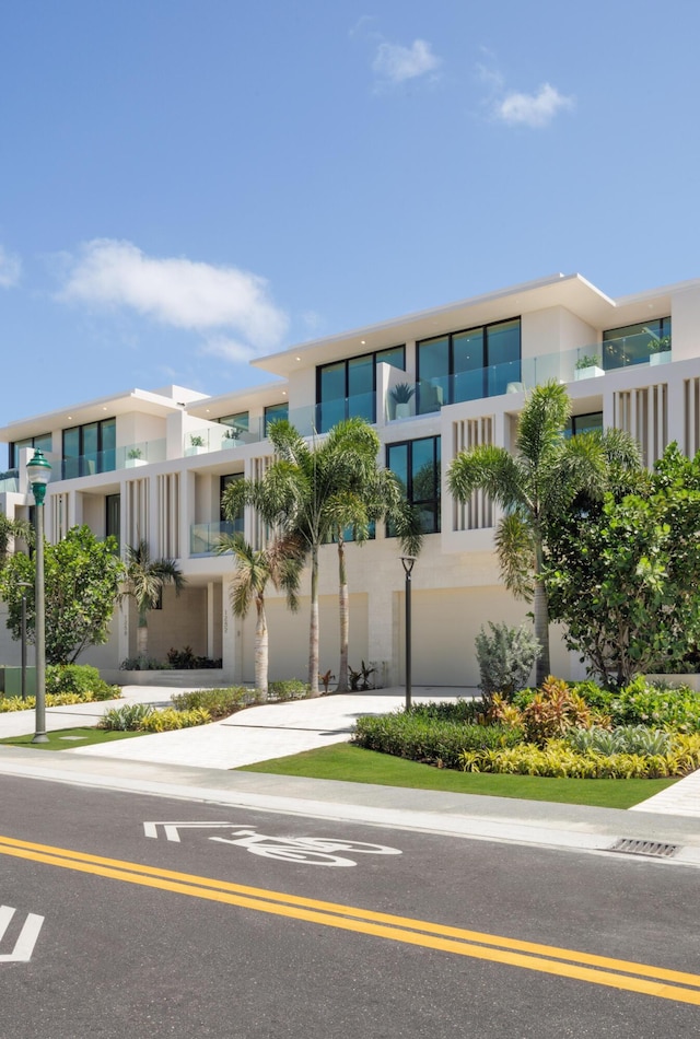 1246 George Bush, Delray Beach, FL 33483 - view of front of home featuring a garage, stucco siding, and driveway