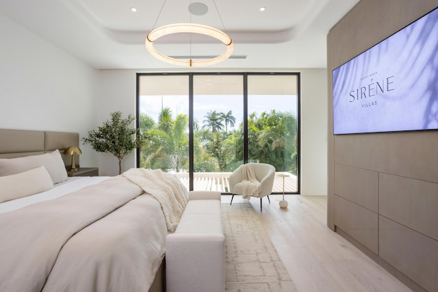 1246 George Bush, Delray Beach, FL 33483 - bedroom featuring a tray ceiling, multiple windows, and light wood finished floors