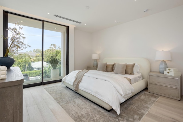 1246 George Bush, Delray Beach, FL 33483 - bedroom with access to outside, recessed lighting, expansive windows, and light wood-style floors