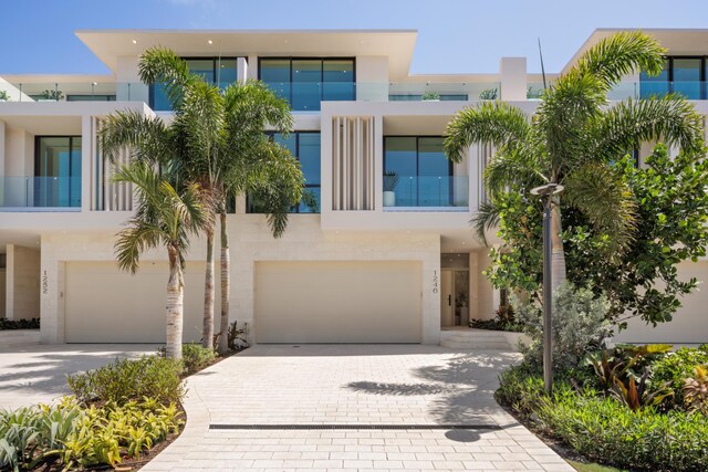 1246 George Bush, Delray Beach, FL 33483 - modern home with an attached garage, stucco siding, and driveway
