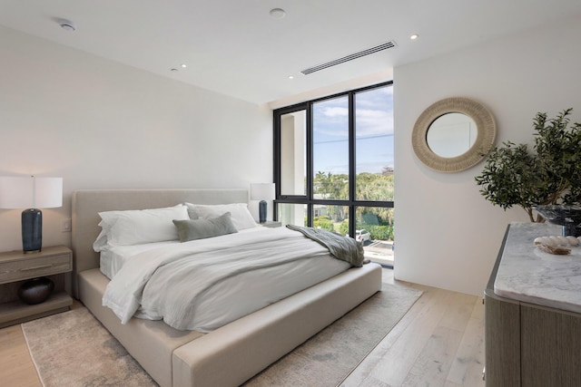 1246 George Bush, Delray Beach, FL 33483 - bedroom with a wall of windows, visible vents, and light wood-style floors