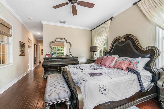bedroom with crown molding, wood finished floors, baseboards, and ceiling fan