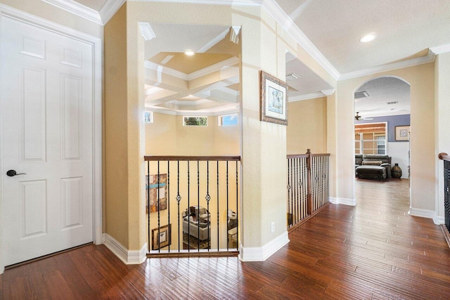 corridor with hardwood / wood-style floors, arched walkways, ornamental molding, coffered ceiling, and baseboards