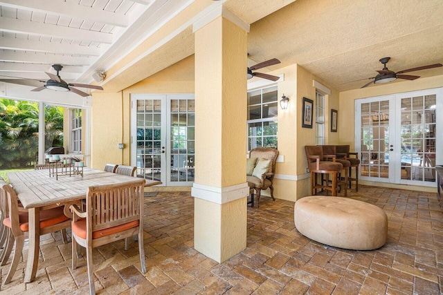 view of patio featuring french doors, a ceiling fan, and outdoor dining space