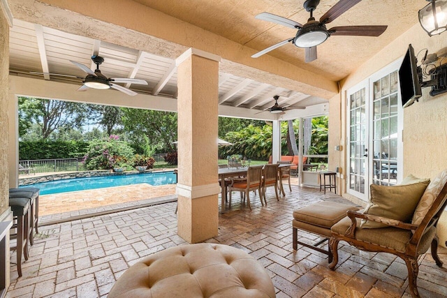 view of patio / terrace featuring a ceiling fan, fence, french doors, and outdoor dining area