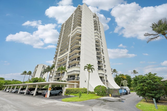 2400 Presidential Way Unit 302, West Palm Beach, FL 33401 - view of apartment building / complex featuring covered parking