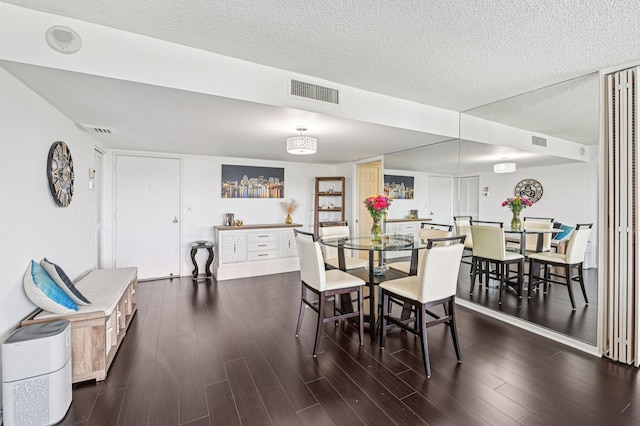 2400 Presidential Way Unit 302, West Palm Beach, FL 33401 - dining area with wood finished floors and a textured ceiling