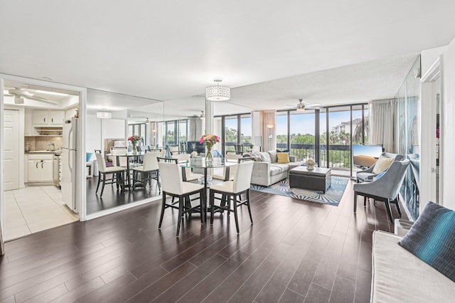 2400 Presidential Way Unit 302, West Palm Beach, FL 33401 - dining area featuring ceiling fan, wood finished floors, and a wall of windows