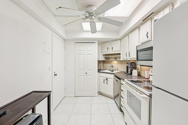2400 Presidential Way Unit 302, West Palm Beach, FL 33401 - kitchen with appliances with stainless steel finishes, backsplash, light tile patterned flooring, a sink, and ceiling fan