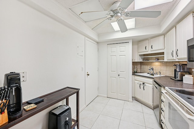 2400 Presidential Way Unit 302, West Palm Beach, FL 33401 - kitchen with a sink, ceiling fan, appliances with stainless steel finishes, dark countertops, and decorative backsplash
