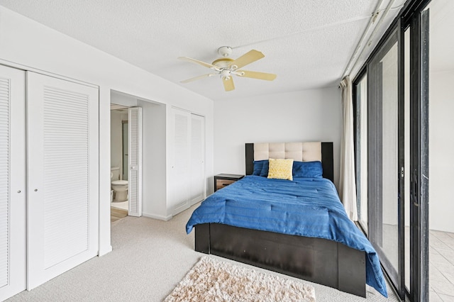 2400 Presidential Way Unit 302, West Palm Beach, FL 33401 - bedroom featuring two closets, carpet flooring, a textured ceiling, a ceiling fan, and baseboards