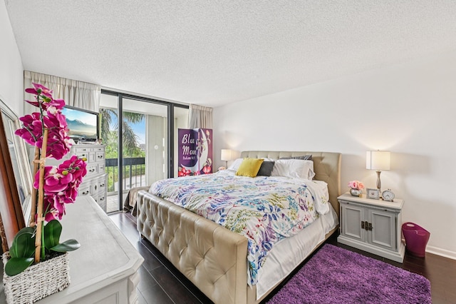2400 Presidential Way Unit 302, West Palm Beach, FL 33401 - bedroom with access to outside, a textured ceiling, dark wood-type flooring, a wall of windows, and baseboards